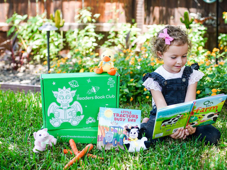 A preschooler holding a book from The Preschool box. Best Preschool subscription program.