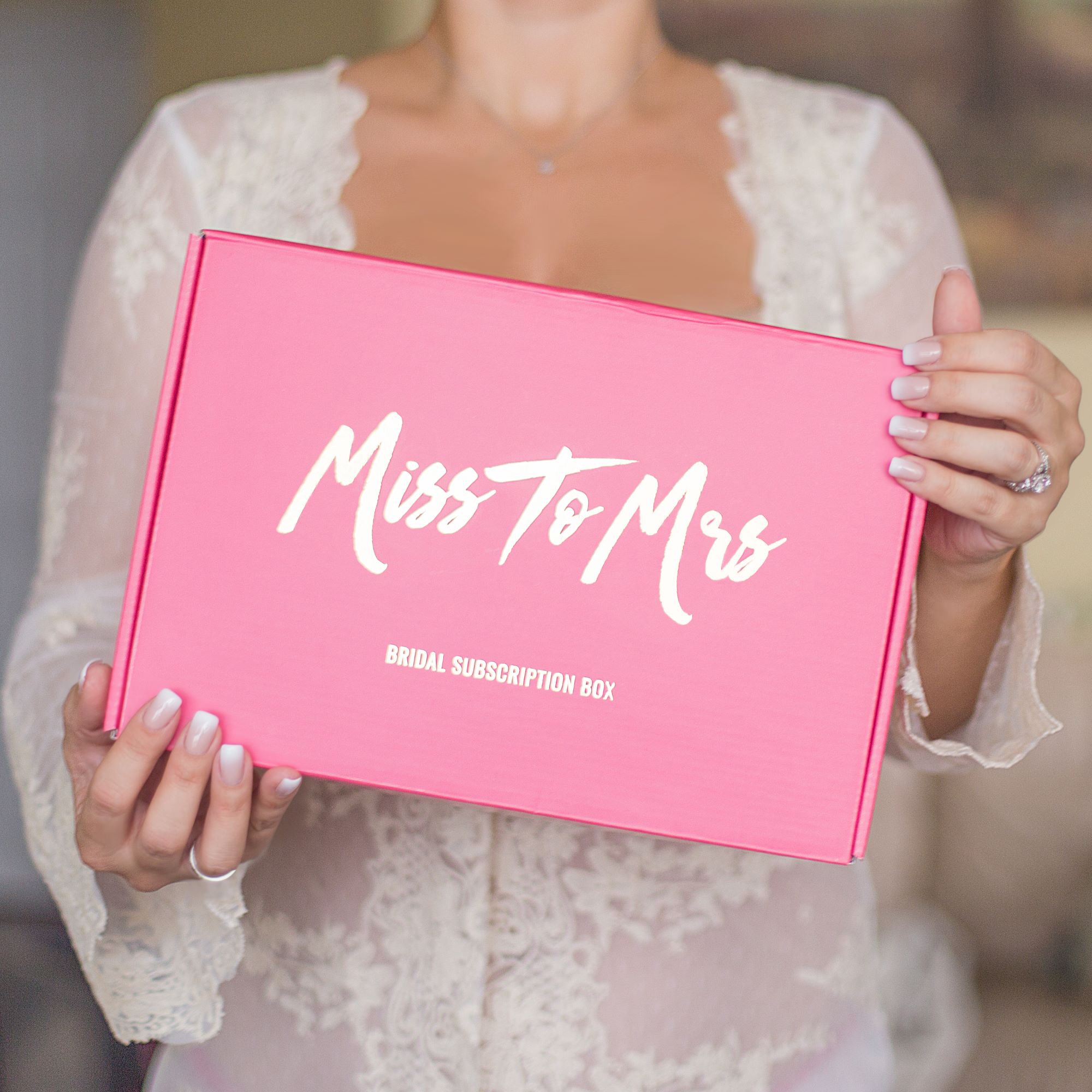 Girl holding a pink Miss to Mrs Bridal Subscription Box